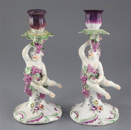 A pair of Derby Dry-edge figural candlesticks, c.1753-55, 22.5cm, restoration to one sconce and one foot